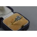 AN 18CT DIAMOND RING, centre stone flank by two diamonds on shoulder, ring size L, approximate