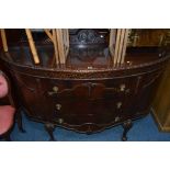 AN EARLY 20TH CENTURY CARVED MAHOGANY BOWFRONT SIDEBOARD, with carved raised back panel, double