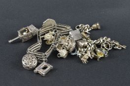 TWO SILVER CHARM BRACELETS, with various charms, approximate weight 141.00 grams