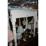 A SMALL VICTORIAN PINE KITCHEN TABLE, with painted base and fablon covering to top (drawer missing)