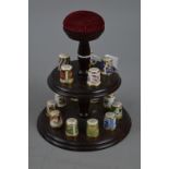 A SET OF FIFTEEN ROYAL CROWN DERBY THIMBLES, all different patterns, complete with stand