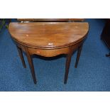 AN EARLY 20TH CENTURY MAHOGANY DEMI LUNE FOLD OVER TEA TABLE