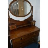 AN EDWARDIAN AND INLAID DRESSING CHEST, with an oval mirror