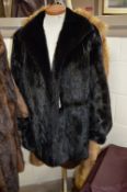 A BLACK FUR JACKET, with label 'Black Excellent Mink', together with a long light brown fur coat (