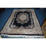 A WOOLLEN CARPET SQUARE, black and cream ground, floral decoration, multi strap border and central