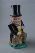 A KIRKLANDS EMBASSY WARE TOBY JUG, depicting seated Winston Churchill in a yellow waistcoat and