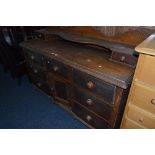 A VICTORIAN GRAIN PAINTED PINE SIDEBOARD, with raised back, two small drawers above seven various