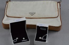 A BOXED PANDORA DAISY RING, and boxed Pandora earrings with a Prada bag