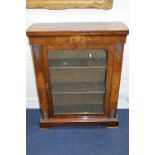 A VICTORIAN WALNUT AND INLAID PIER CABINET, with brass mounts and the glazed single door revealing
