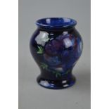 A SMALL MOORCROFT POTTERY VASE, 'Anemone' pattern on blue ground, impressed marks to base, height