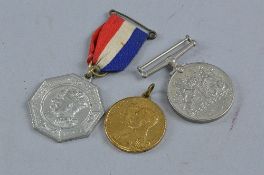 A WWII DEFENCE MEDAL, (no ribbon), together with a Middlesex County Council silver coloured