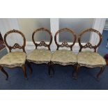 A SET OF SIX VICTORIAN ROSEWOOD BALLOON BACK CHAIRS, with carved and pierced backs on cabriole