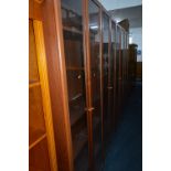 FOUR MODERN TALL OAK GLAZED BOOKCASES