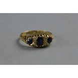 AN EARLY 20TH CENTURY 18CT GOLD SAPPHIRE AND DIAMOND HALF HOOP RING, three oval mixed cut sapphires,