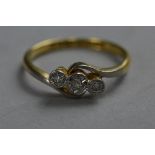 AN 18CT THREE STONE CROSSOVER DIAMOND RING, ring size M, approximate weight 2.8 grams