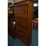 AN OAK STANDING OPEN BOOKCASE