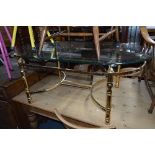 A GLASS TOPPED COFFEE TABLE, on a brass frame, approximate width 126cm x depth 71.5cm x height 50cm