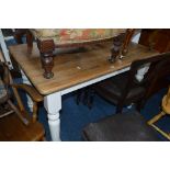 AN EARLY 20TH CENTURY PINE KITCHEN TABLE, on a painted base, approximate size width 102cm x depth