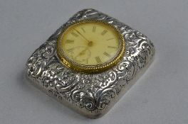 A SILVER AND BRASS TRAVEL CLOCK