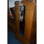 AN OAK THREE PIECE BEDROOM SUITE, consisting of a single mirror door wardrobe, dressing chest and