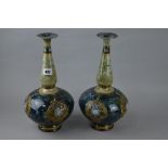 A PAIR OF ROYAL DOULTON STONEWARE BOTTLE VASES, each underglaze painted in tones of blue, green