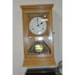 A LIGHT OAK WALL CLOCK, manufactured by The National Time Recorder Co, London (winding keys and case