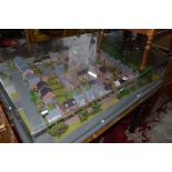 A DETAILED 3D PLANNING MODEL OF A HOUSING ESTATE, in a perspex case, approximate size width 121cm