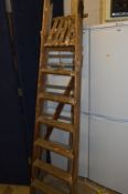 A SET OF WOODEN STEP LADDERS, and a set of aluminium step ladders