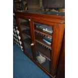 A VICTORIAN WALNUT GLAZED TWO DOOR BOOKCASE, with adjustable shelving, approximate size width