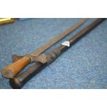 A BLACK COLOURED WOODEN WALKING CANE, possibly African in origin, carved decoration below grip,
