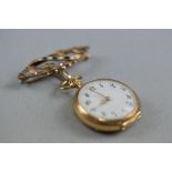 AN EARLY 20TH CENTURY LADIES FOB WATCH, white enamel dial with Arabic numerals and fancy fine scroll