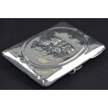 AN EDWARDIAN SILVER RECTANGULR NOTE CASE, repousse decorated with Reynold's Angels within an oval,