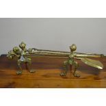 A VICTORIAN BRASS COMPANION SET, with ball and claw detail, comprising of a pair of trivets and