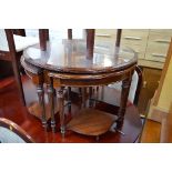 A MODERN MAHOGANY CIRCULAR COFFEE TABLE, a nest of tables, a pair of mahogany wine tables and two