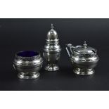 A THREE PIECE CRUET SET, with blue glass lining on two of them, Birmingham 1936