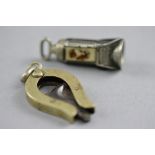 AN ENAMEL CIGAR CUTTER, and another (2)