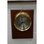 A 20TH CENTURY SHIPS'S BELL STRIKING BULKHEAD CLOCK, inscribed Bell Clock Co. Quartz, wall mounted