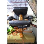 A BLACK LEATHER STYLE SWIVEL CHAIR, and a footstool (23)