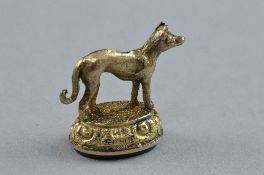 A 9CT HARDSTONE FOB IN THE FORM OF A DOG, slight damage, approximate weight 2.9 grams