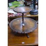 AN OAK CIRCULAR TWO TIER REVOLVING CAKE STAND