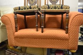 AN UPHOLSTERED TWO SEATER SOFA