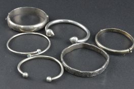 A BAG OF MIXED SILVER BANGLES, approximate weight 130 grams (6)