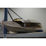 A MODEL CABIN CRUISER/SPEED BOAT, missing engine, length approximately 122cm (in need of attention)