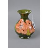 A SMALL MOORCROFT POTTERY VASE, Hibiscus pattern on green ground, paper label to base and