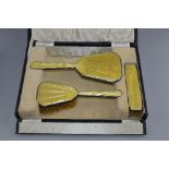 A YELLOW ENAMEL AND SILVER THREE PIECE DRESSING SET, boxed