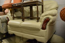 A CREAM LEATHER THREE PIECE SUITE, comprising of a two seater sofa and a pair of armchairs