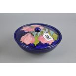 A MOORCROFT POTTERY COVERED POWDER BOWL, Magnolia pattern on blue ground, impressed marks to base,