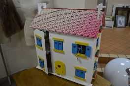 A TWO STOREY DOLLS HOUSE, with blue and yellow painted windows, roof slides reveal attic, with