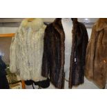 TWO SHORT FUR JACKETS, brown which is quite stiff and a white fox fur which has stained lining (2)