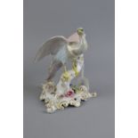 A ROYAL CROWN DERBY CHELSEA BIRD, pink, grey and blue plummage, on a flower encrusted tree stump and